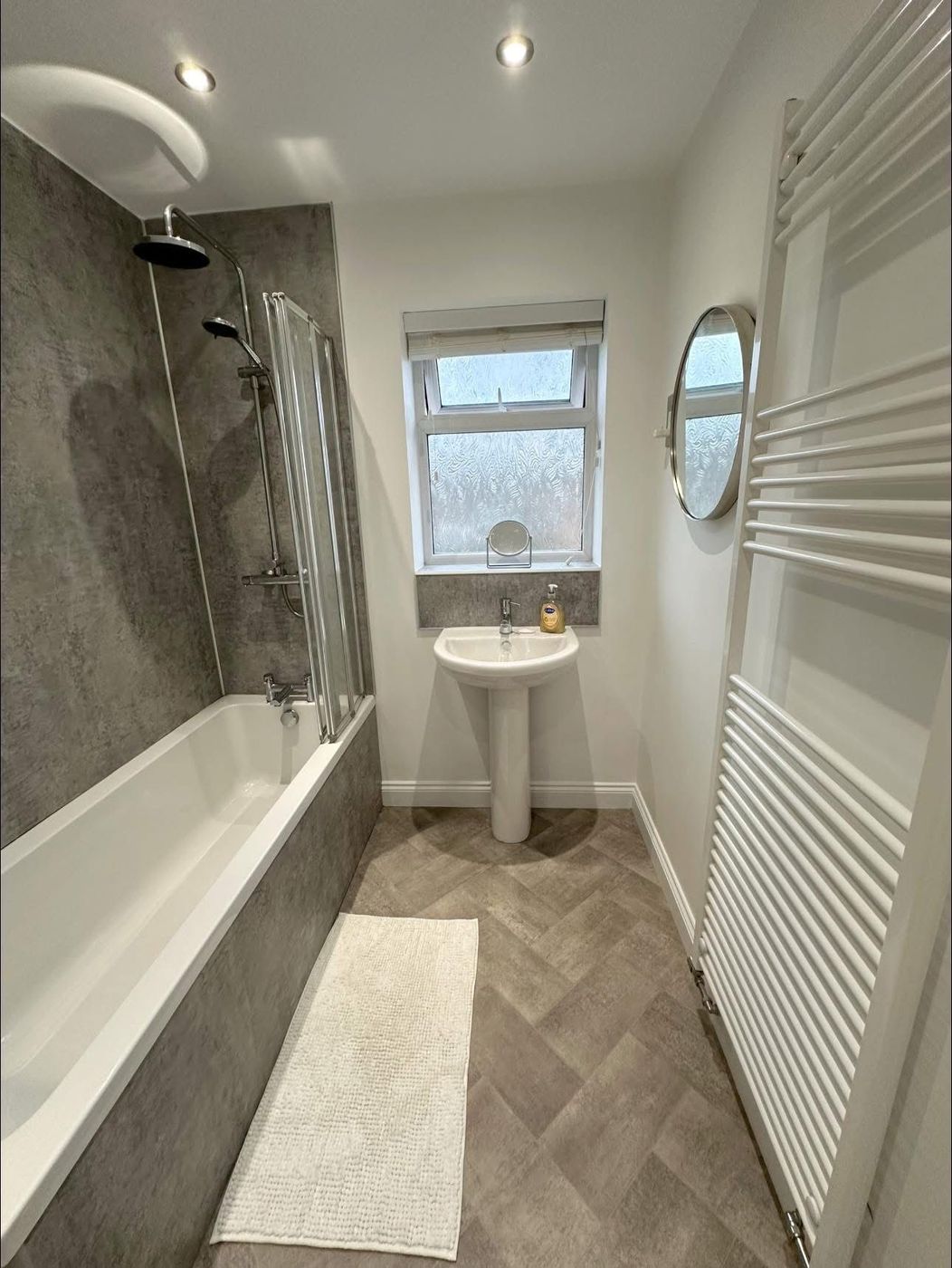 Renovated bathroom with shower over bath