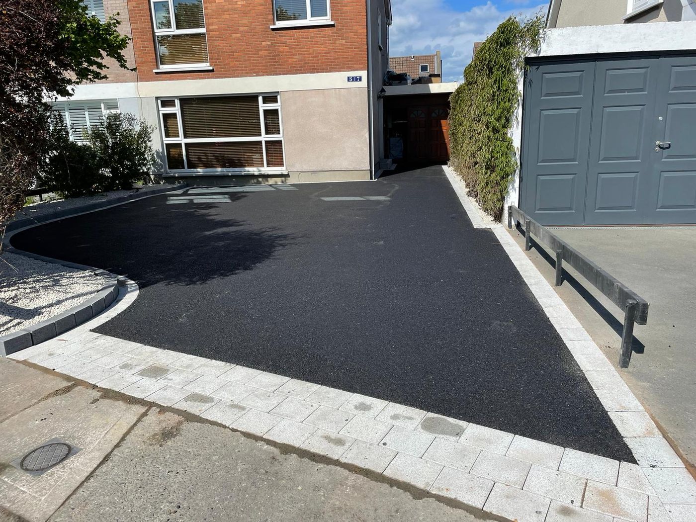Tarmac driveway with a granite paving border