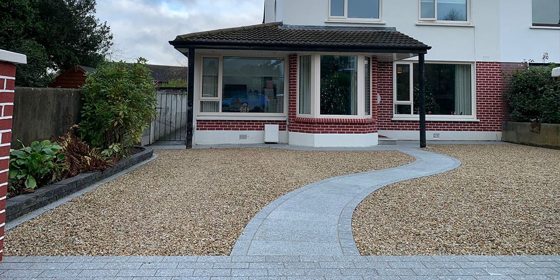 Front garden with gravel and a curved granite path
