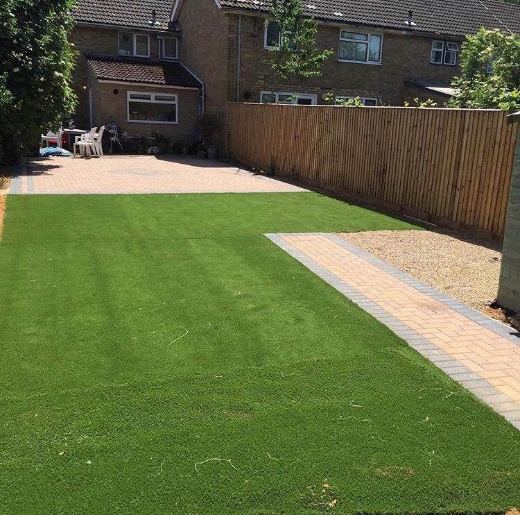 Tidy back garden with lawn, patio and fence